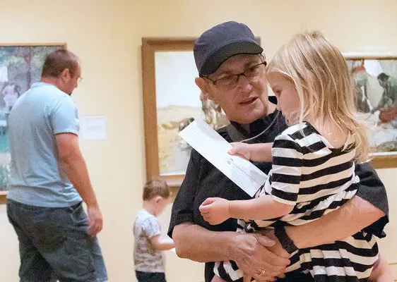 A womman and a little girl explore an art museum together, representing the values of legacy and planned giving in a cultural setting